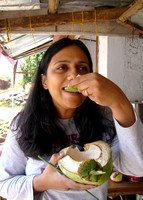 Eating young coconut at a roadside stand
