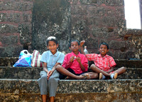 Kids sitting on ruins, Old Goa