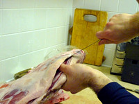 "Pocketing" - cutting the meat along the ribs to create a pocket for the rice.
